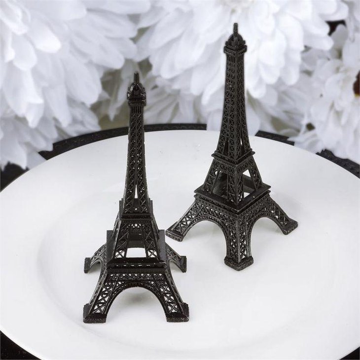 Two miniature Eiffel Tower replicas on tablescape