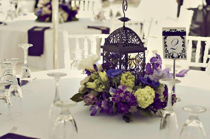 Unique purple birdcage centerpiece for wedding table