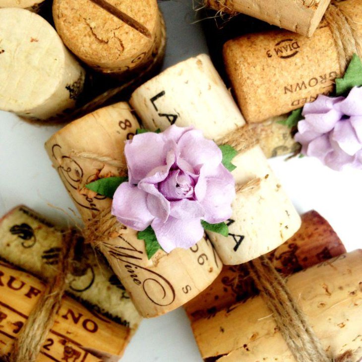 Unique winter table decor with wine cork place card holders wrapped with twine and flower