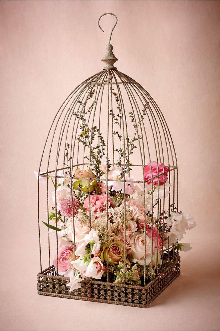 Vintage birdcage centerpiece with pastel floral accents
