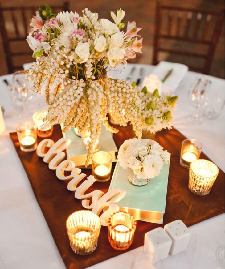 Vintage book and votive vignette wedding table centerpiece