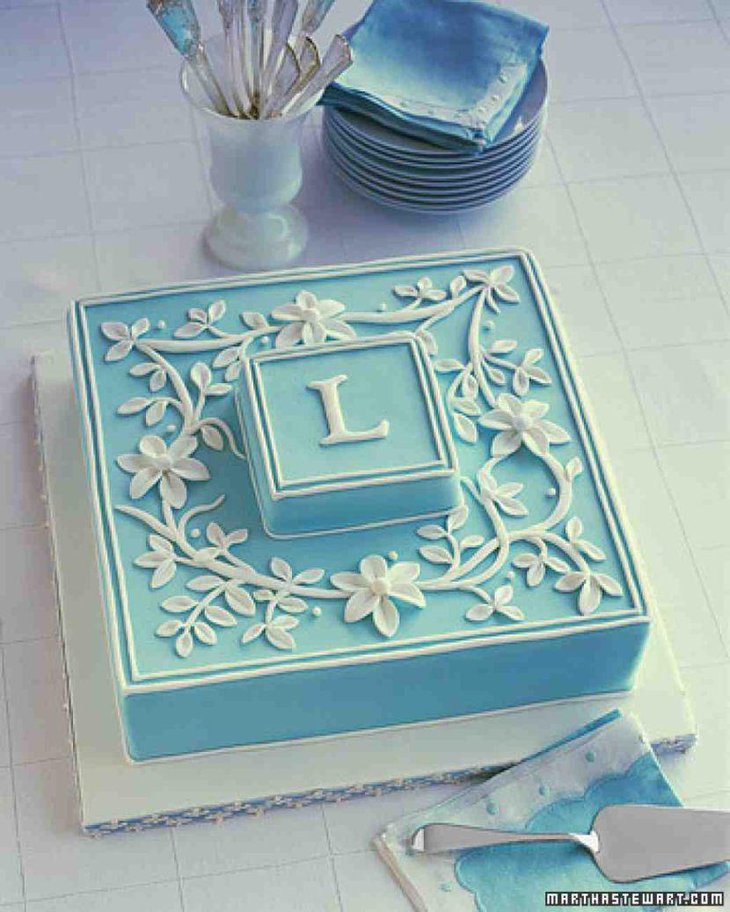 Vintage bridal shower dessert table decor with blue cake adorned with monogram
