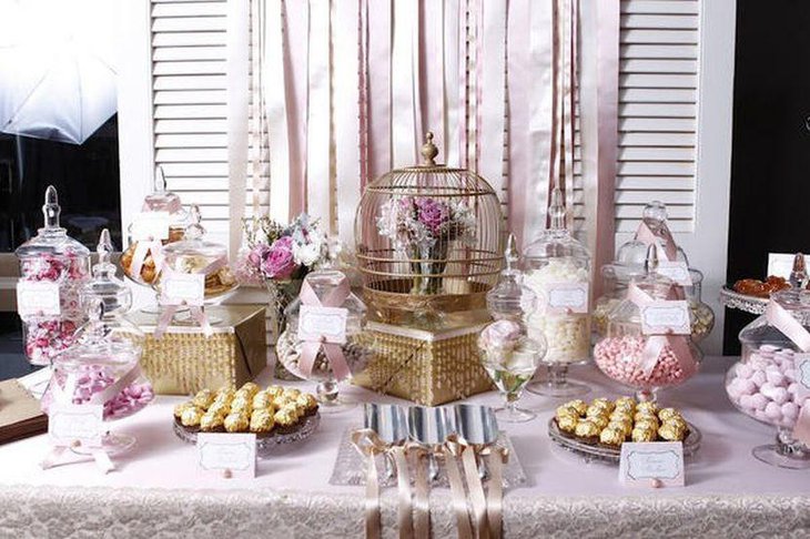 Vintage DIY wedding candy table decor with golden cage filled with flowers