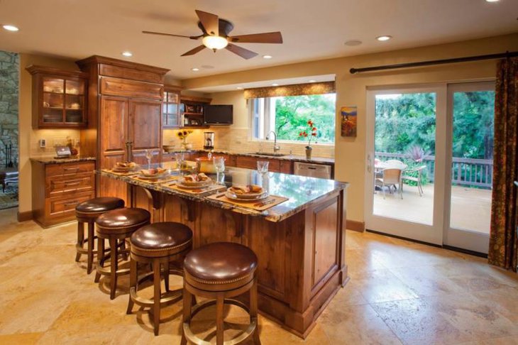 Warm Breakfast Nook With Marble Topped Island Brown Leather Barstools