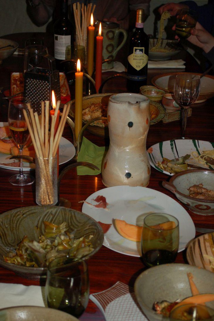 Warm Italian themed table decor using candles and bread sticks