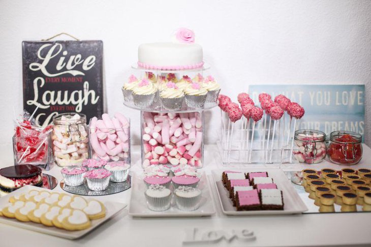 Wedding cake table decor with pink candy and heart shaped cookies