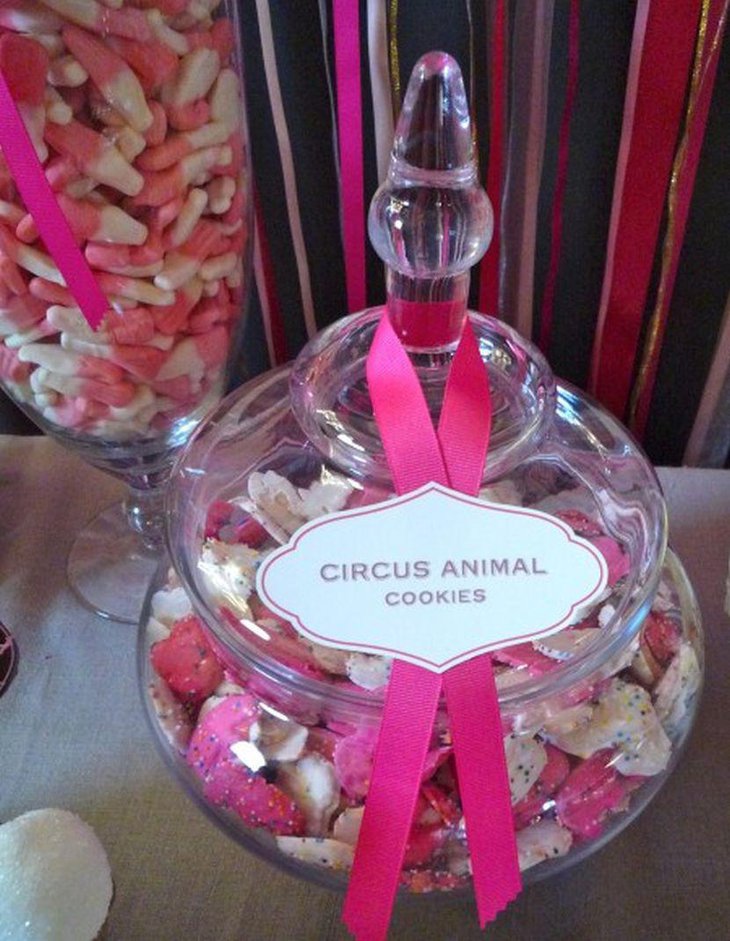Wedding dessert table decor with a glass jar filled with circus animal shaped cookies