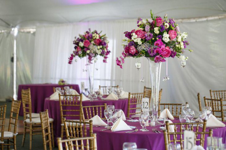 Wedding table decor with purple tablecloth and flowers