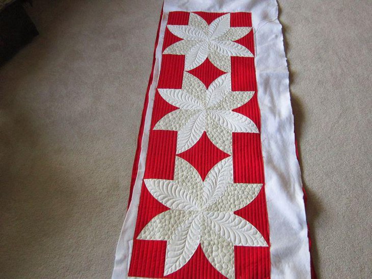 White and red quilted Valentines table runner with flower pattern