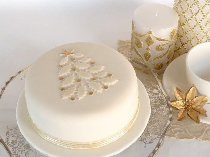 White Christmas cake decorated with golden star and dots