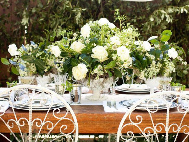 White floral decor on an outdoor bridal shower table