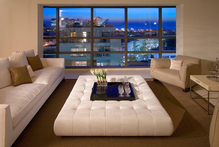 White ottoman coffee table setting with tray and glasses