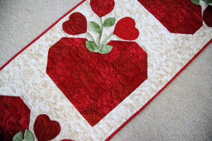 White quilted Valentines table runner with red hearts and buds