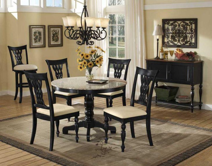 White round granite dining table top and dark wooden chairs