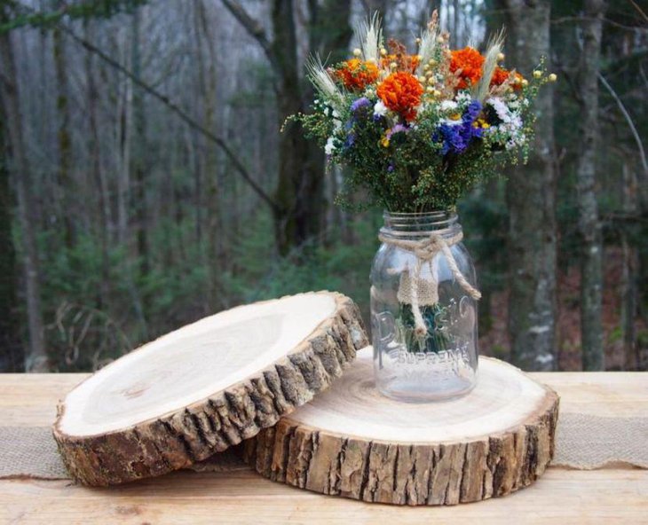 Wooden slabs with mason jar decor on a country wedding table