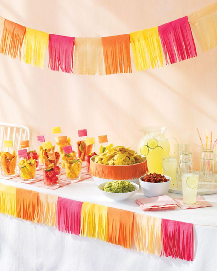 Yellow and pink themed Mexican table decor using tissue paper