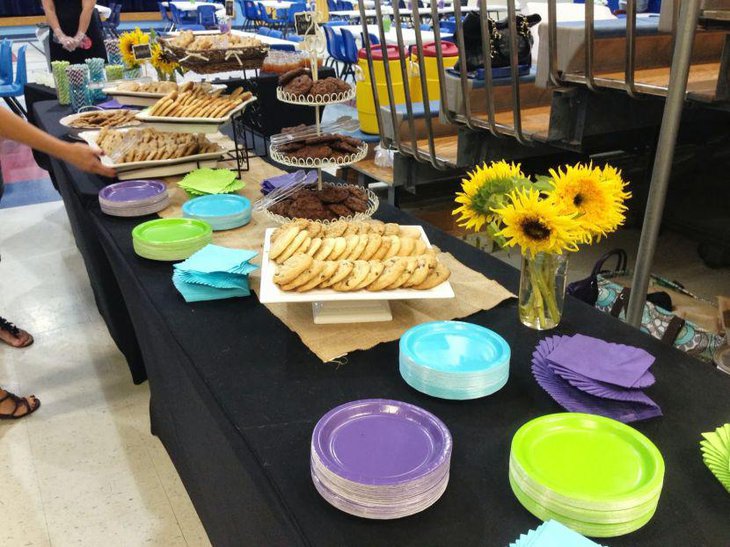 Yellow floral centerpieces displayed on 80th birthday table of a grandma